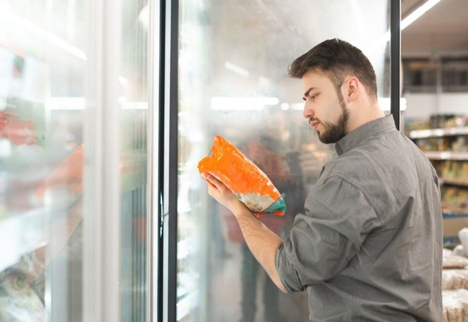 Man at fridge looking at meat